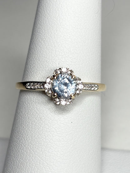 A 9k gold ring with a Montana sapphire and white zircon halo.