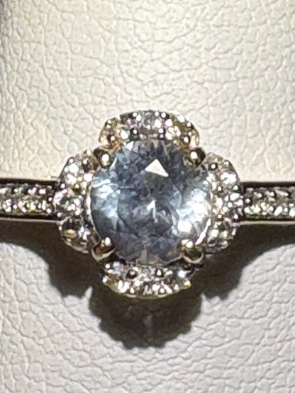 A light blue Montana sapphire floral halo ring with white zircon in 9k gold.
