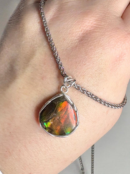Natural ammolite pendant necklace in sterling silver with a braided style.