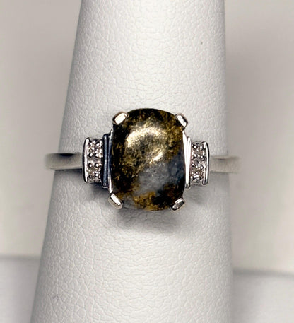 A 10k white gold ring with a cushion-shaped California gold in quartz stone and small diamonds.