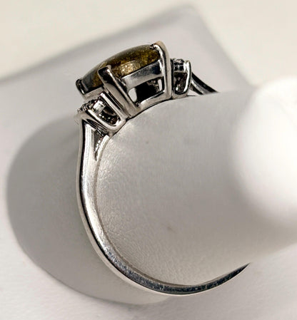 10k white gold ring with a cushion-cut gold in quartz center stone and small diamonds.