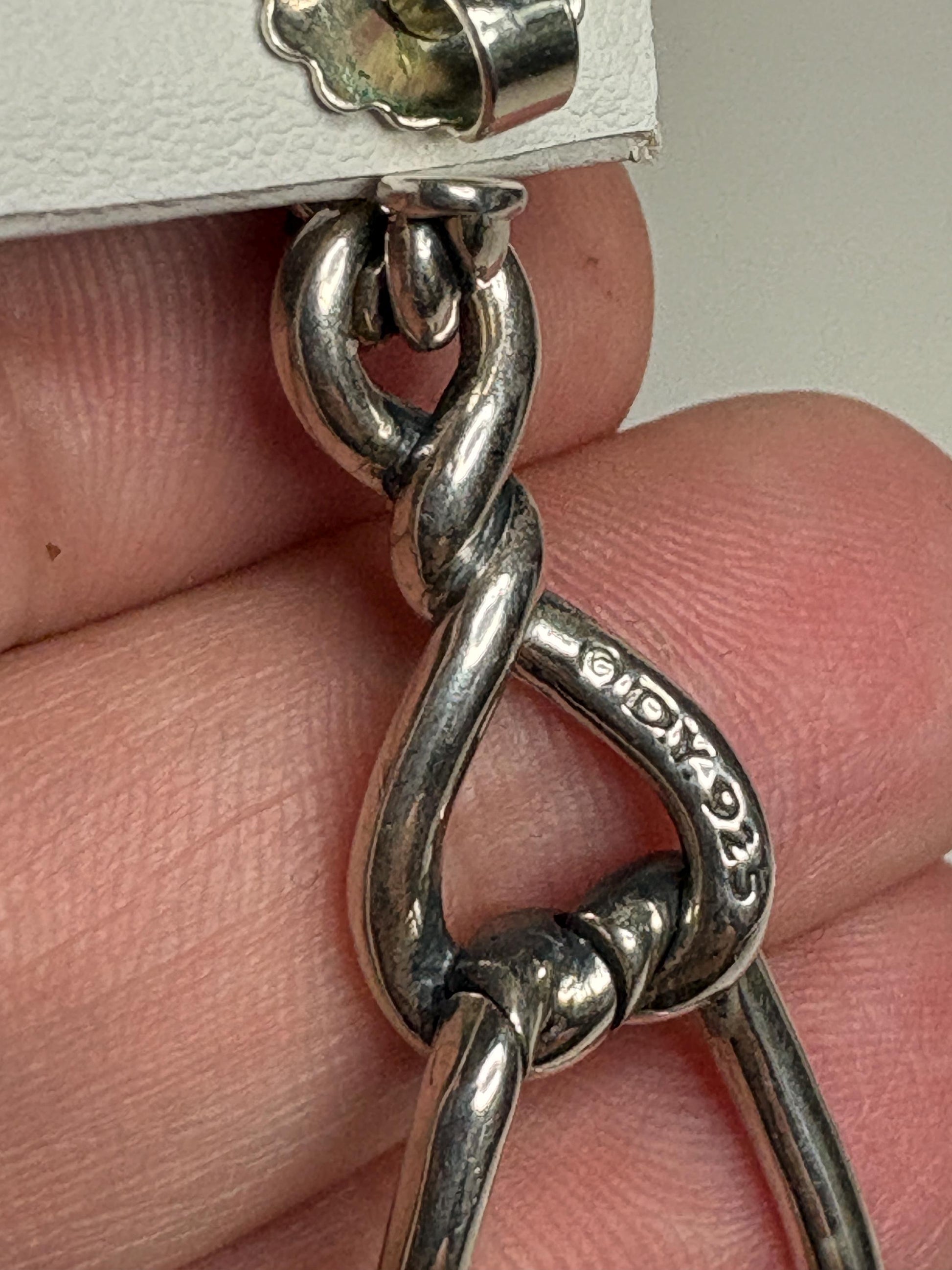 Sterling silver dangle earrings with a twisted rope design and a DY mark.