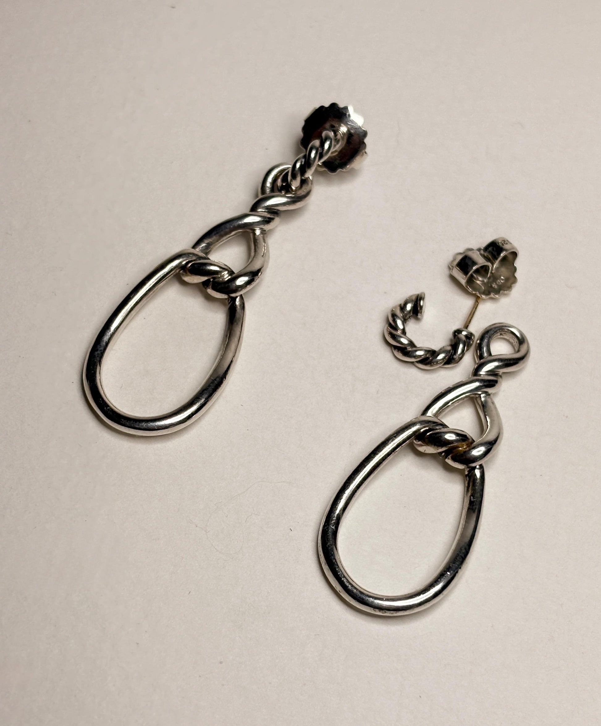 Sterling silver dangle earrings with twisted rope detail and 14k gold posts.