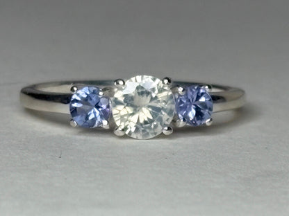Sterling silver ring with a central off-white zircon and two tanzanite stones.
