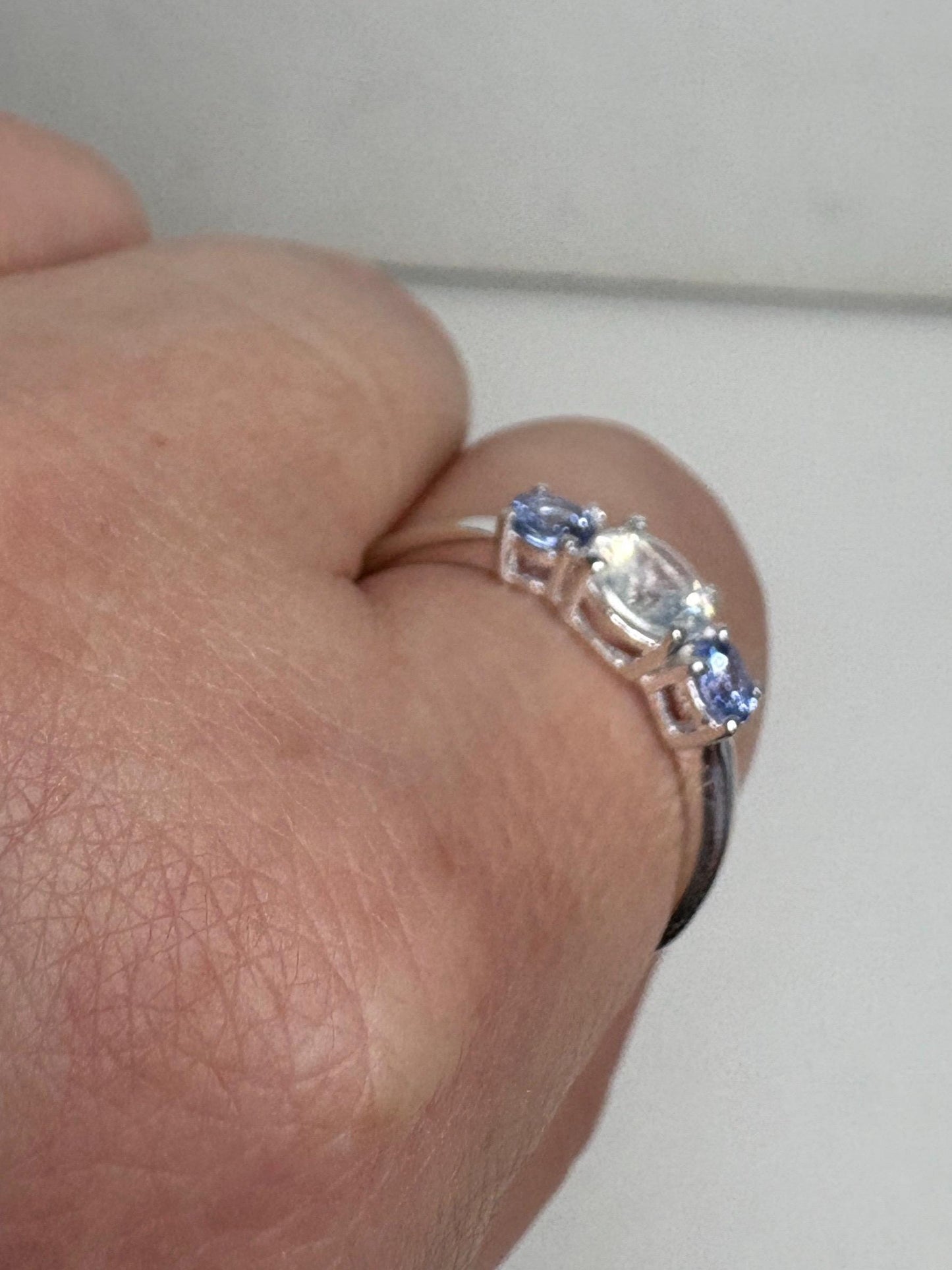 Sterling silver ring with a milky zircon and two tanzanite stones.
