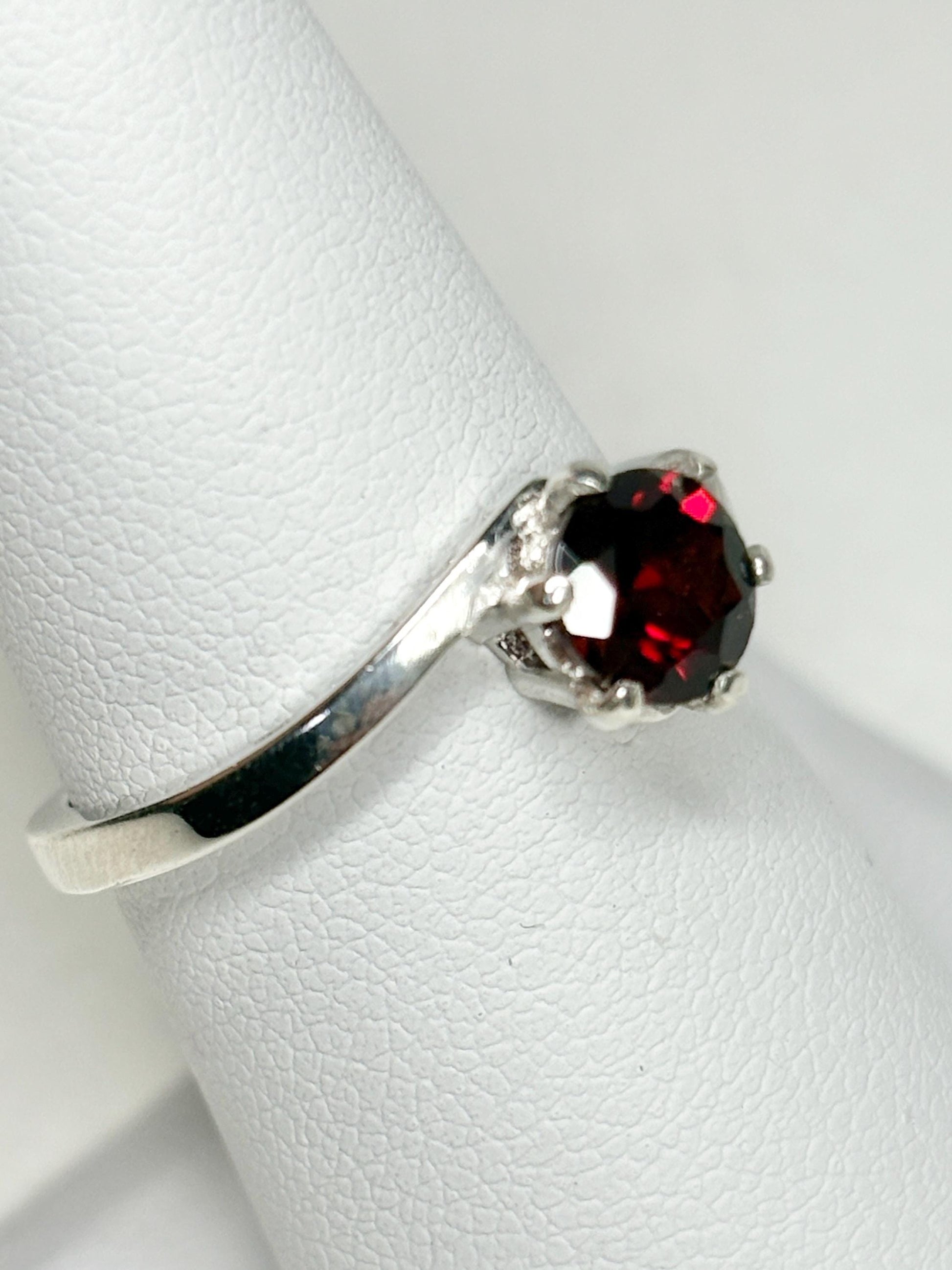 Sterling silver bypass ring with a round pyrope garnet.