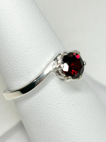 Sterling silver bypass ring with a round pyrope garnet.