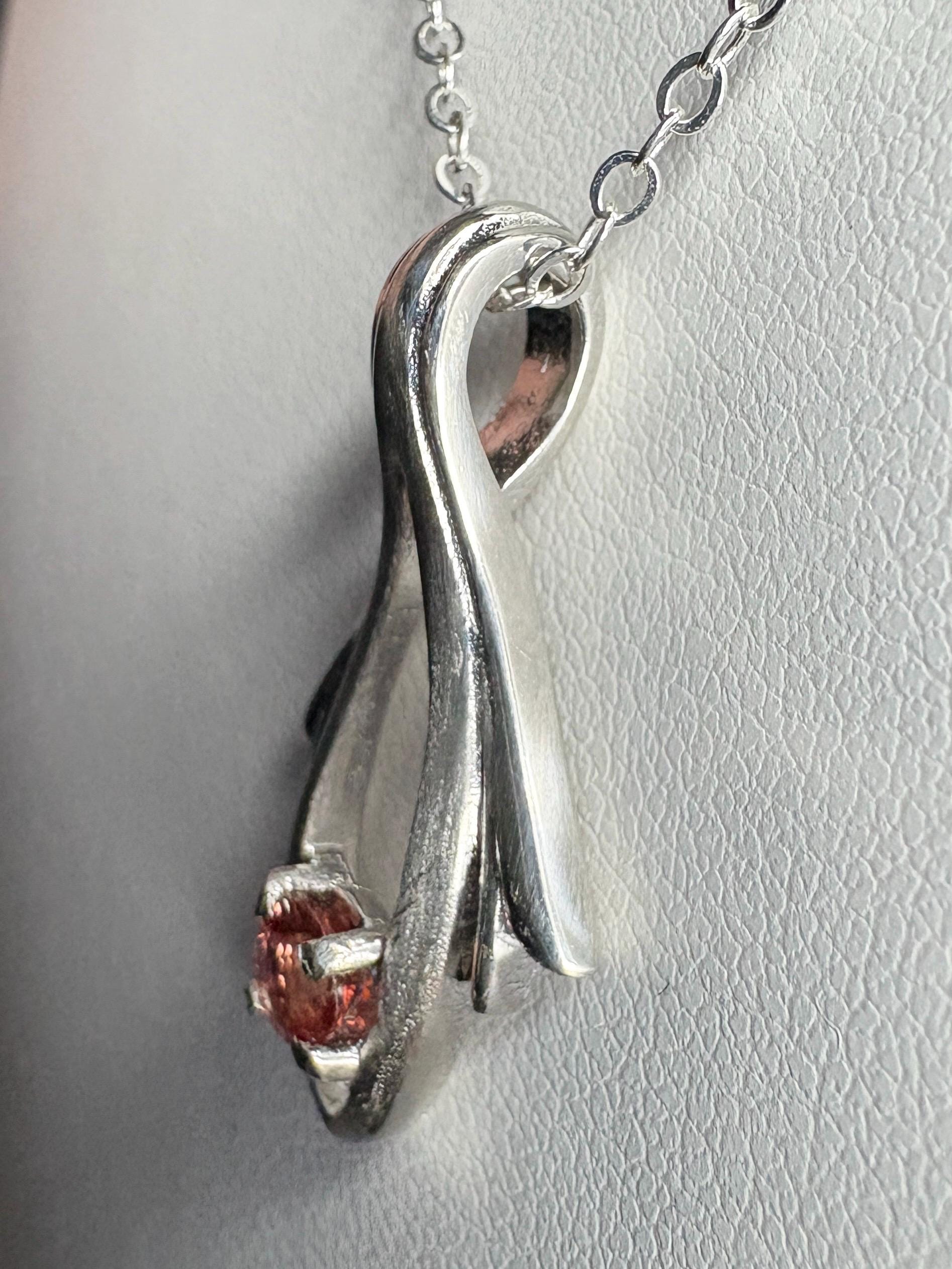 Sterling silver pendant necklace with a light red Oregon sunstone.