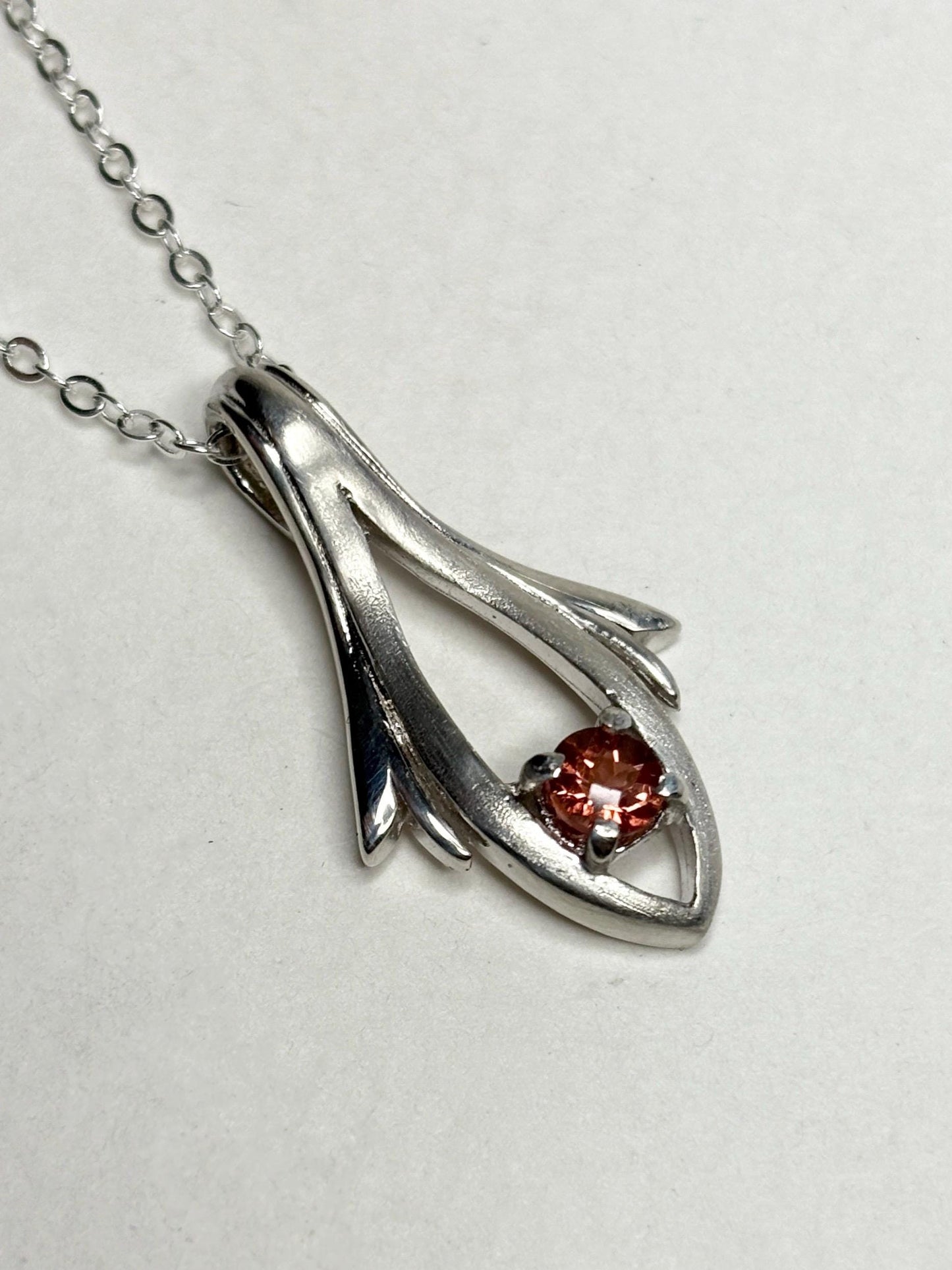 Sterling silver pendant necklace with a light red Oregon sunstone.