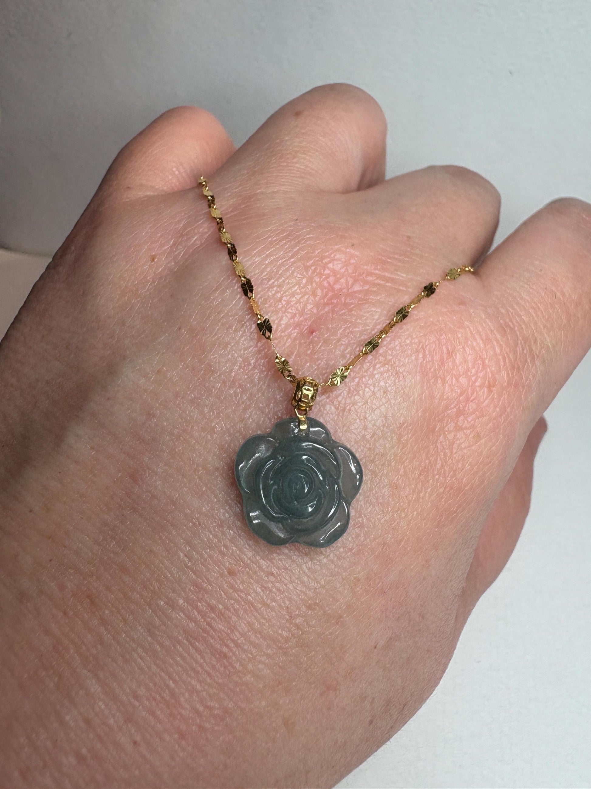 Teal jadeite rose pendant on an 18k gold bail and 14k gold chain.