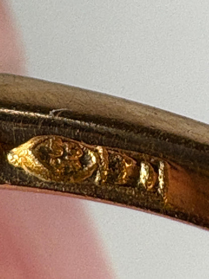 Solid 21k gold lily bypass ring with white stones.