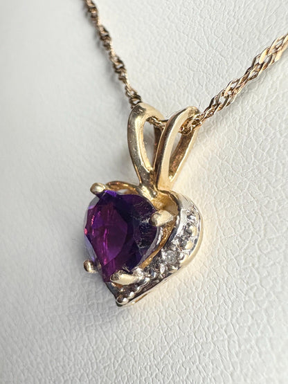 Heart-shaped amethyst and diamond pendant on a 14k gold rope chain.