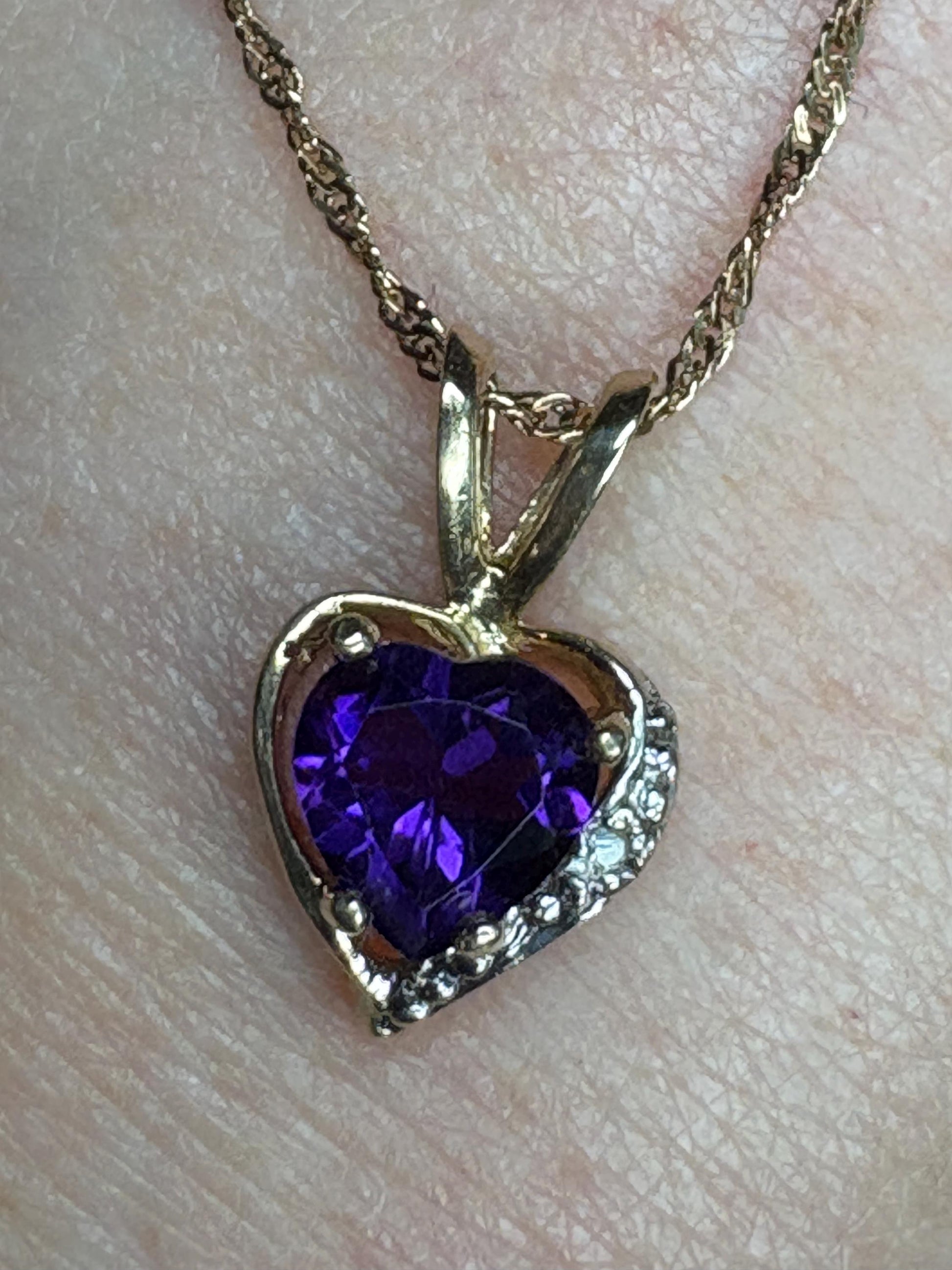 Heart-shaped amethyst and diamond pendant on a 14k gold chain.