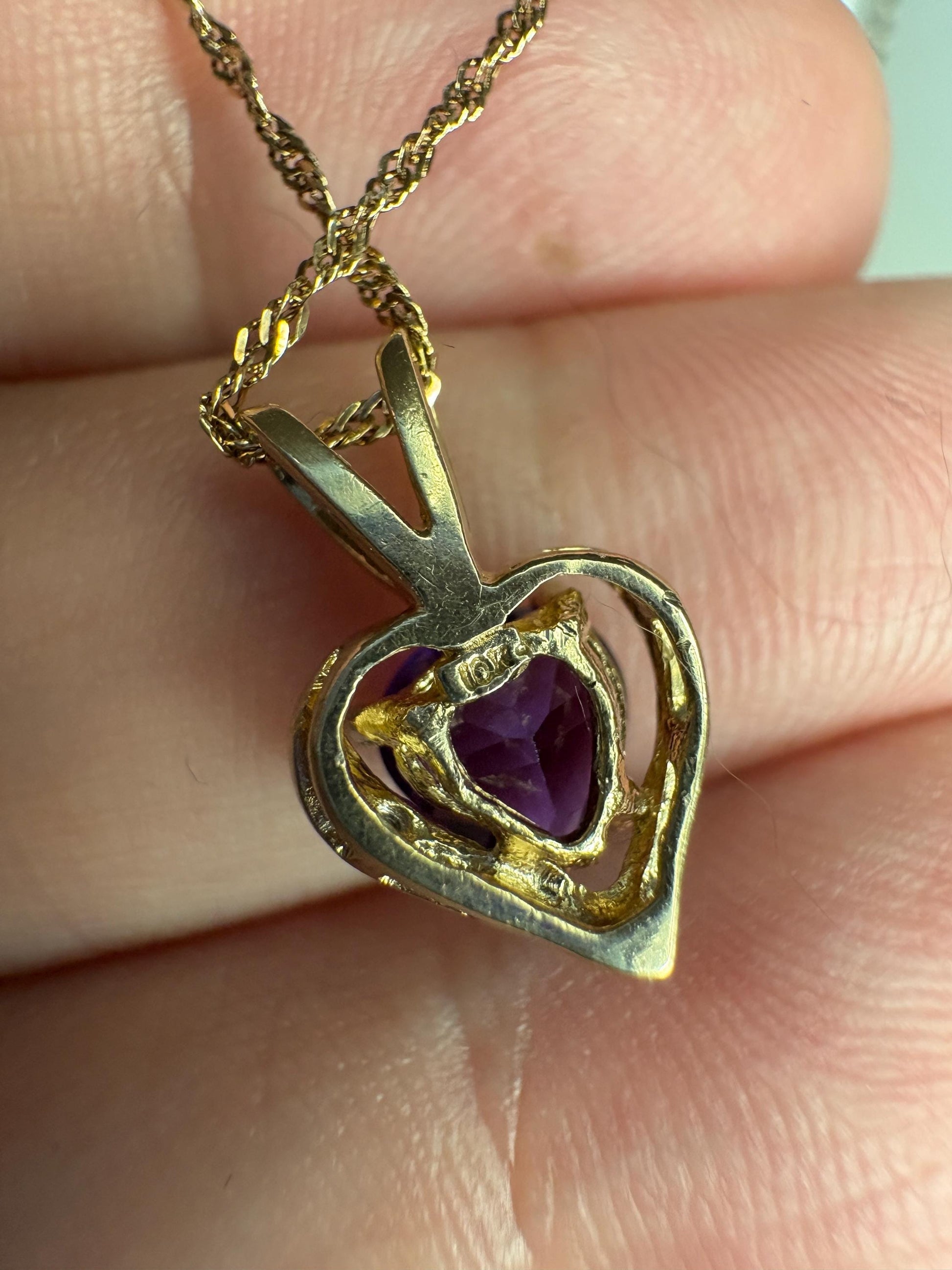 A 10k gold heart pendant with amethyst and diamond on a 14k gold chain.