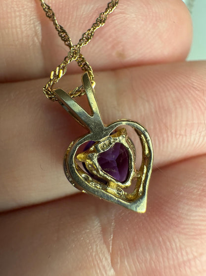 A 10k gold heart pendant with amethyst and diamond on a 14k gold chain.