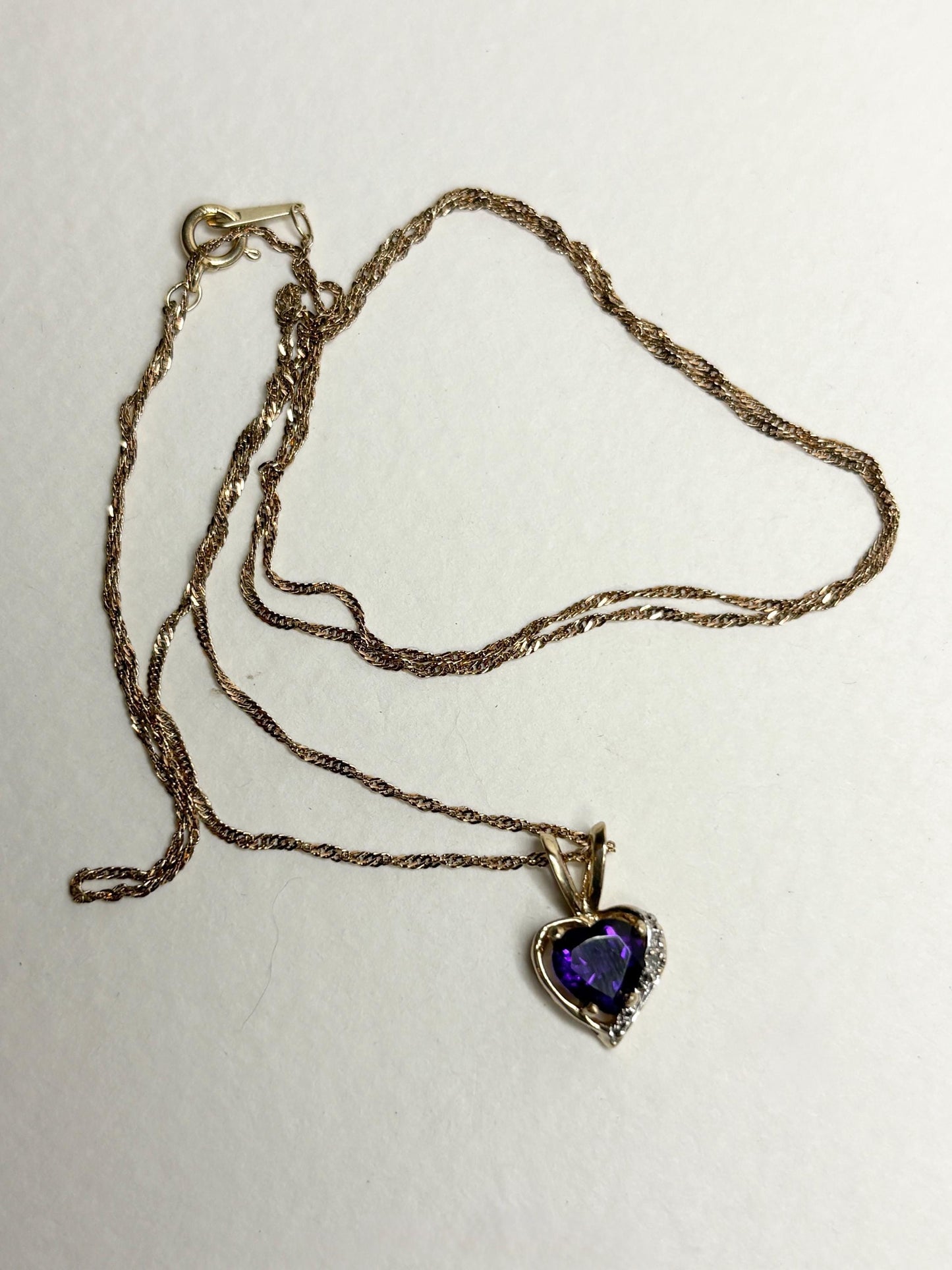 14k gold chain with a 10k gold heart pendant featuring an African amethyst and diamond.