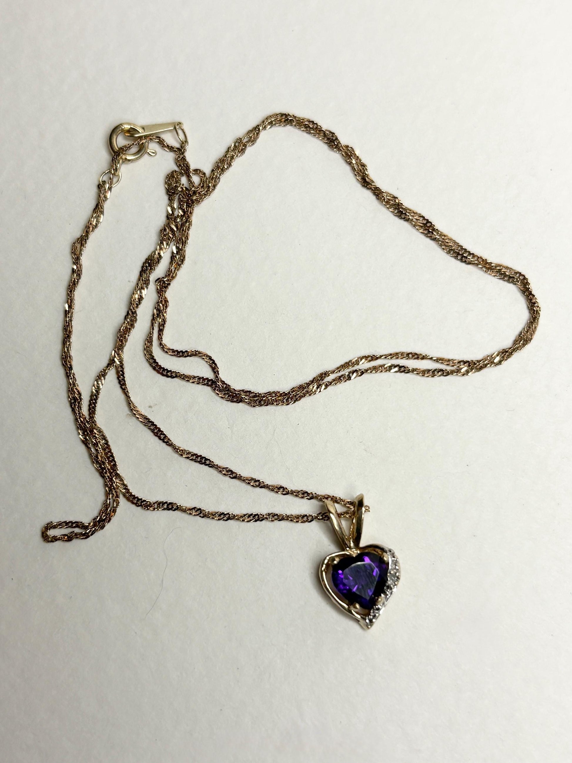 14k gold chain with a 10k gold heart pendant featuring an African amethyst and diamond.