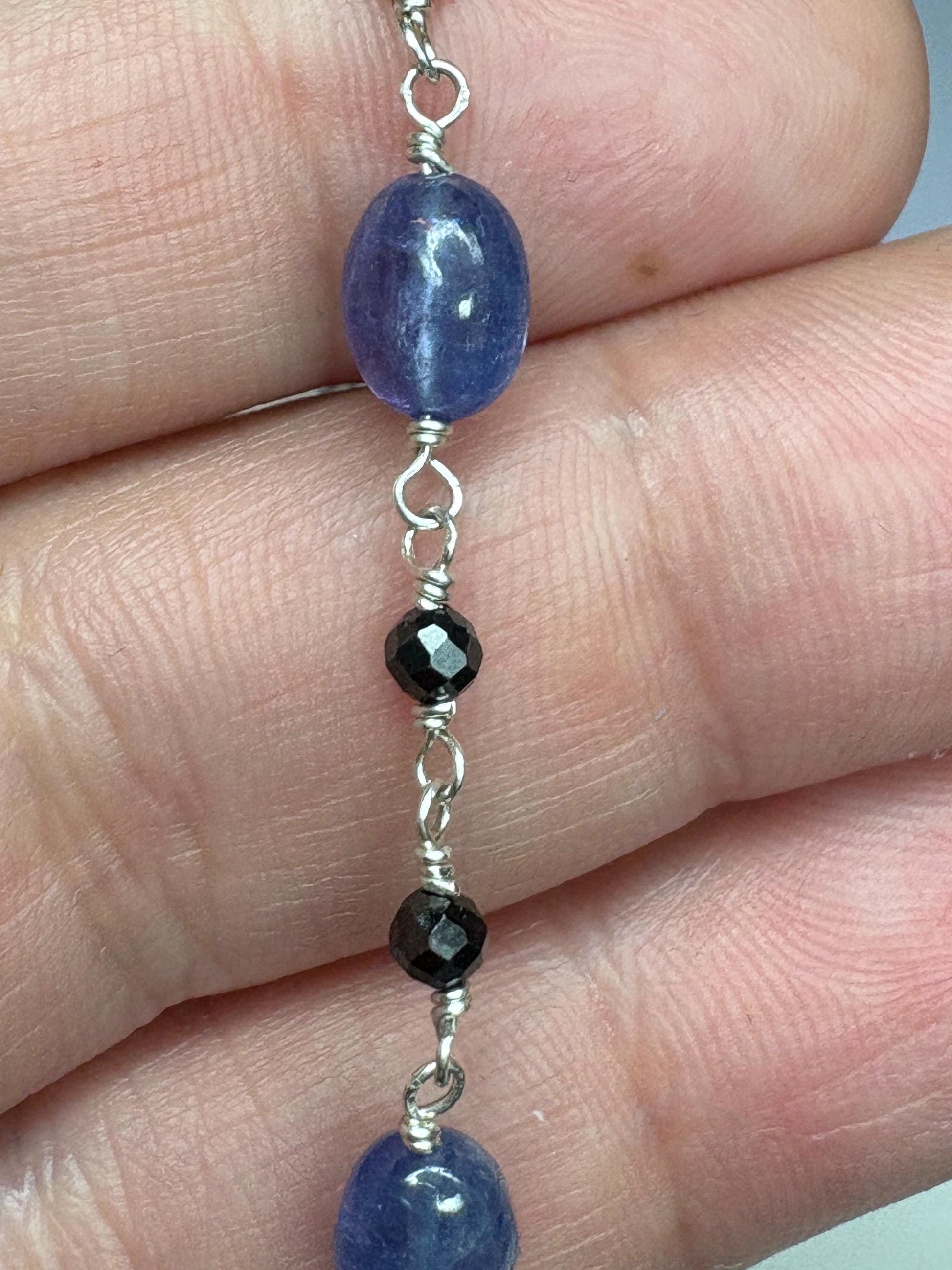 Sterling silver bracelet with oval tanzanite and faceted black diamond beads.