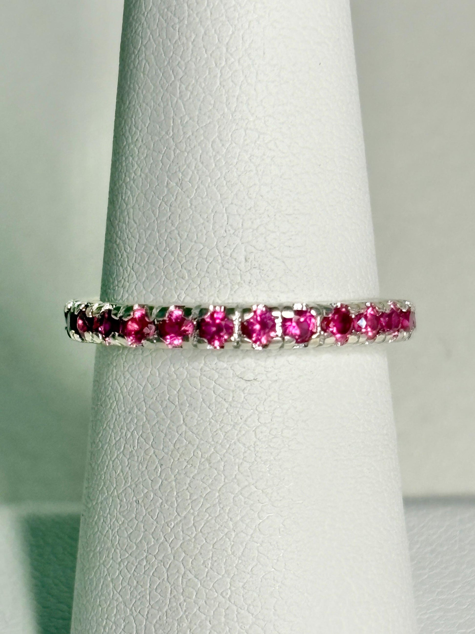 Hot pink lab-grown sapphire eternity ring in solid sterling silver.