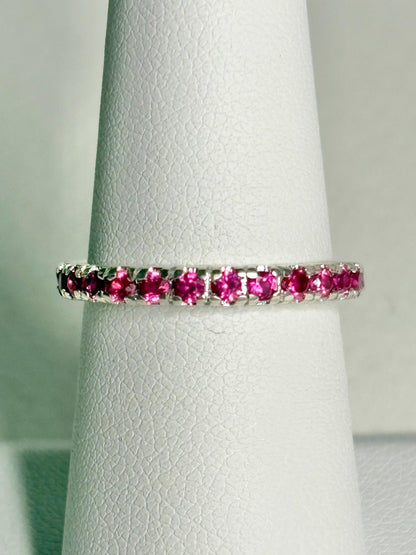 Hot pink lab-grown sapphire eternity ring in solid sterling silver.