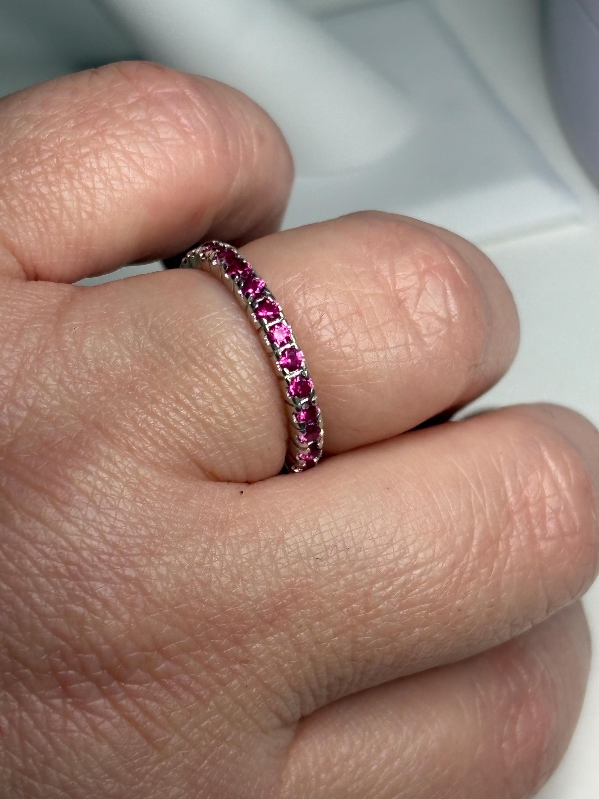Hot pink lab-grown sapphire eternity ring in sterling silver.