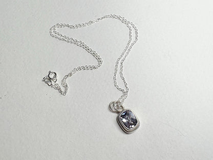 Sterling silver necklace with a lavender checkerboard faceted CZ solitaire pendant.