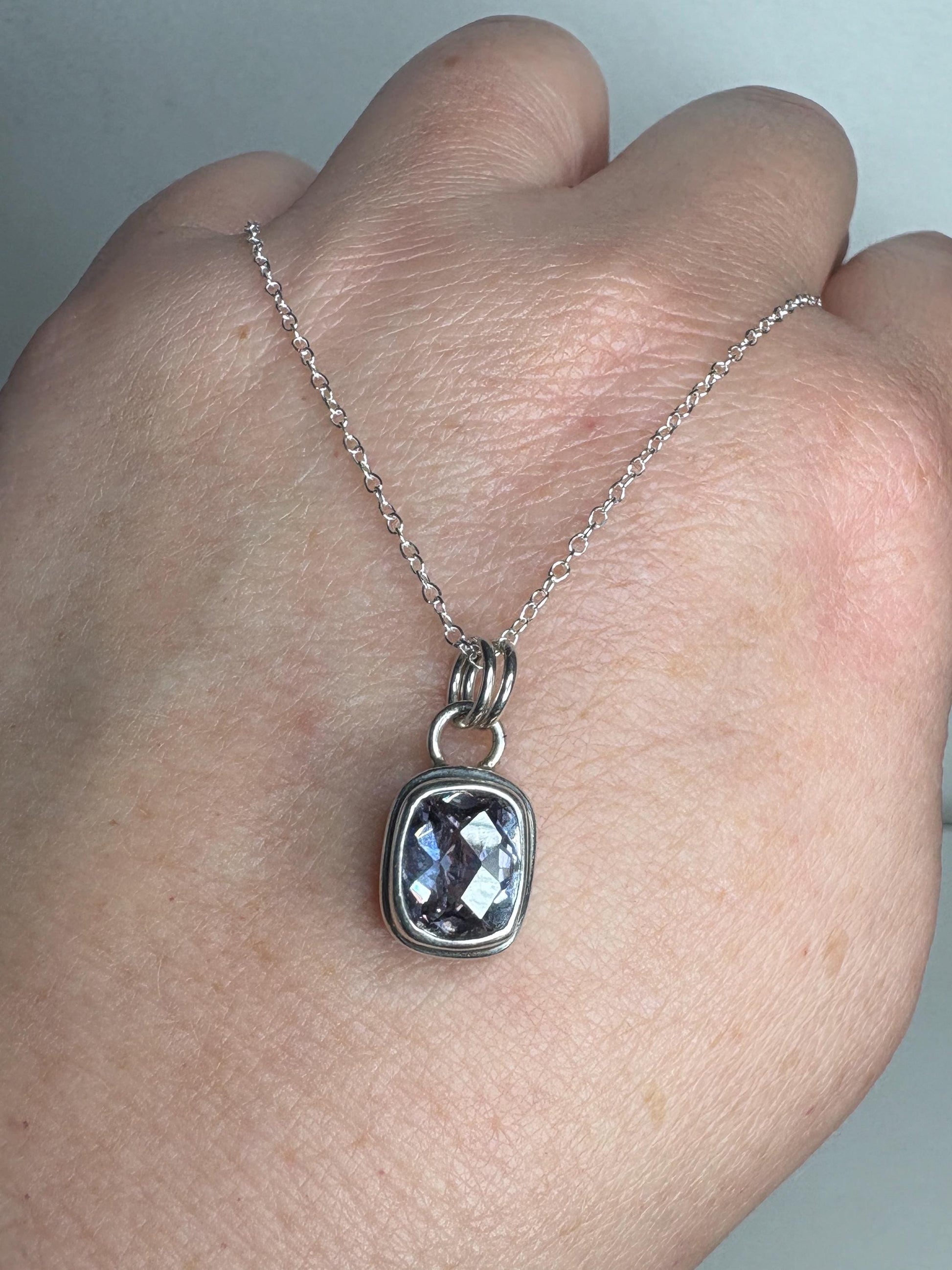 Sterling silver necklace with a lavender checkerboard faceted CZ solitaire pendant.