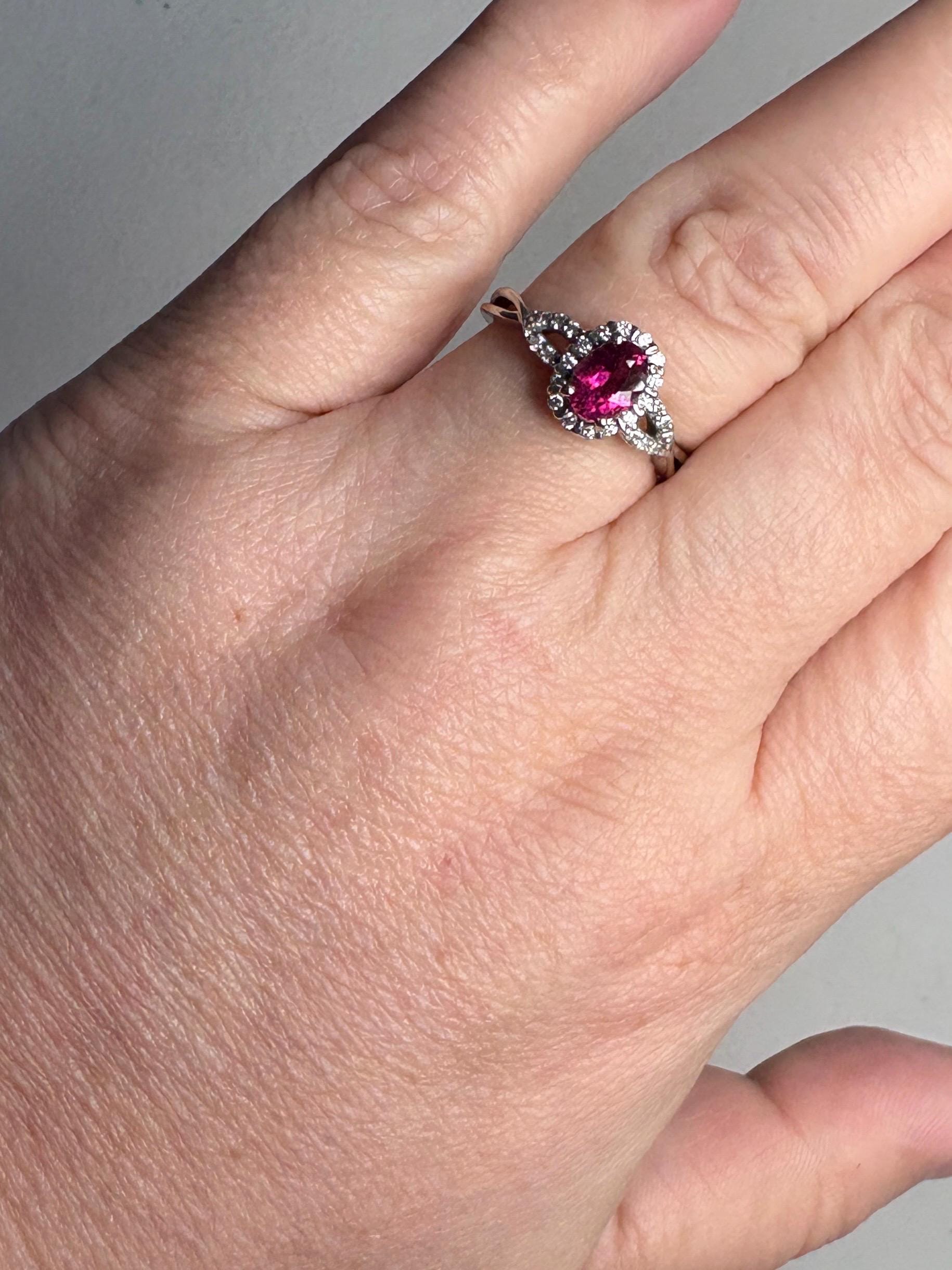 Rubellite tourmaline and diamond halo ring in 10k white gold.