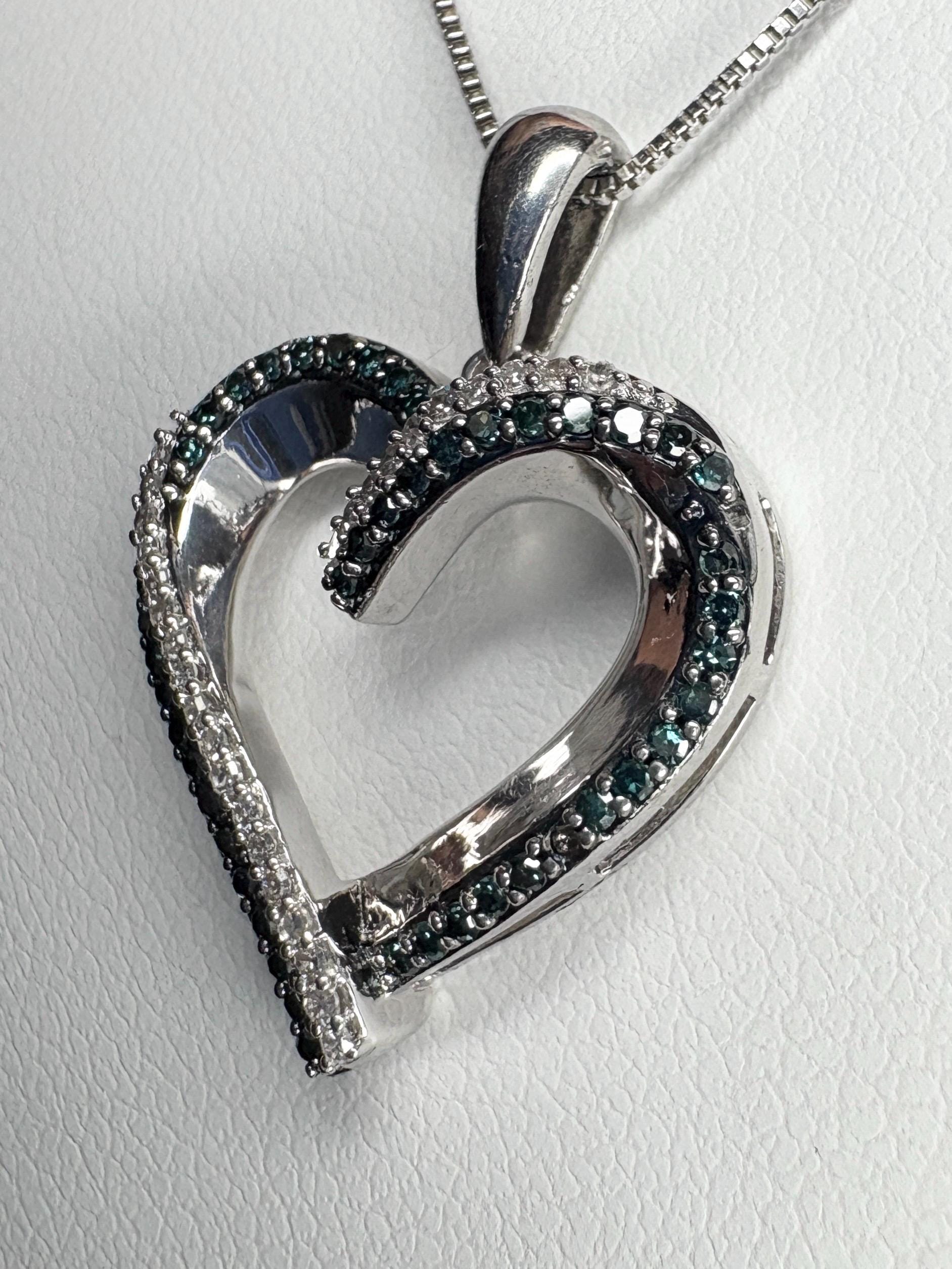Sterling silver heart pendant necklace with blue and white diamonds.