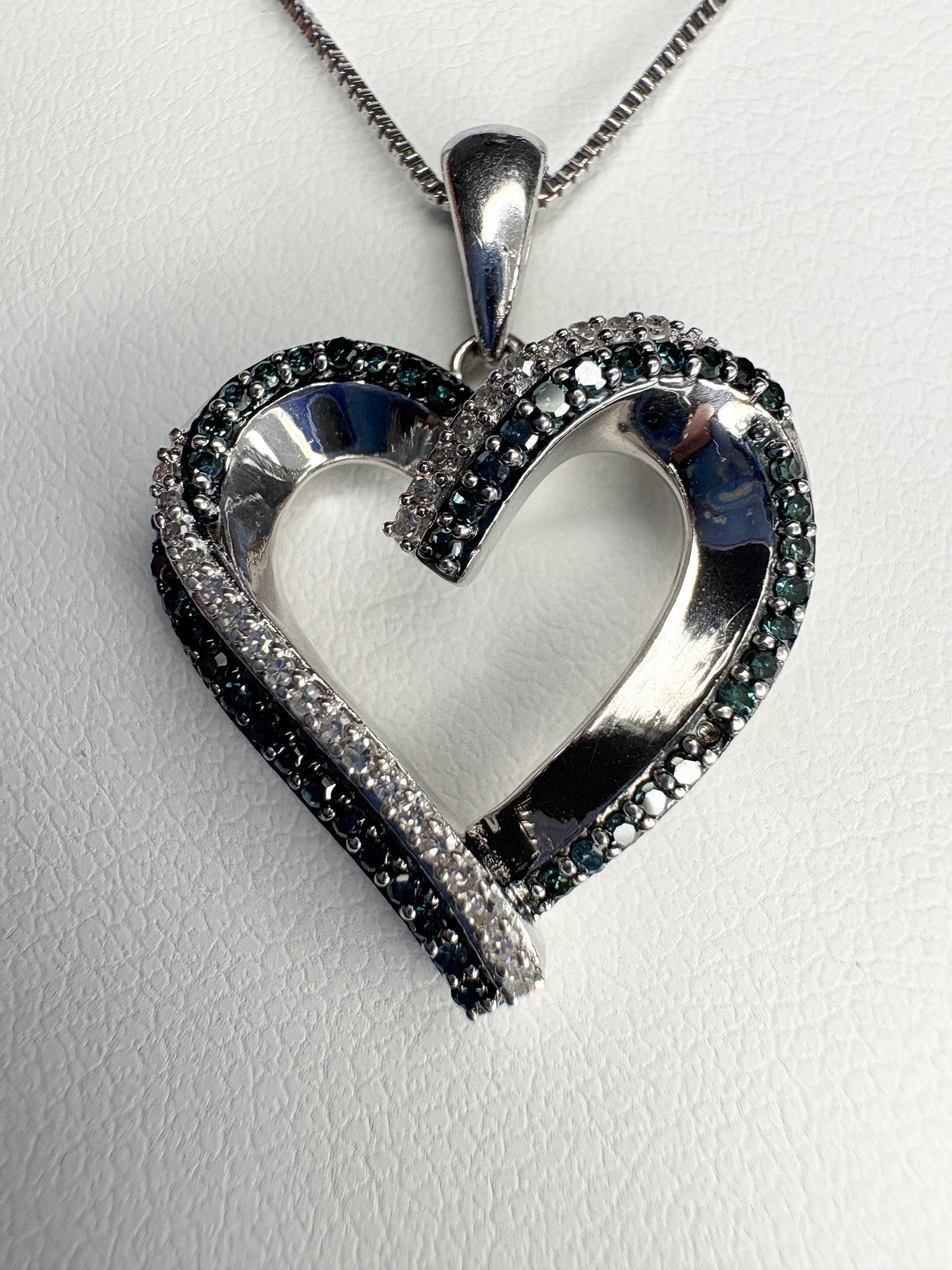 Sterling silver heart pendant necklace with blue and white diamonds.