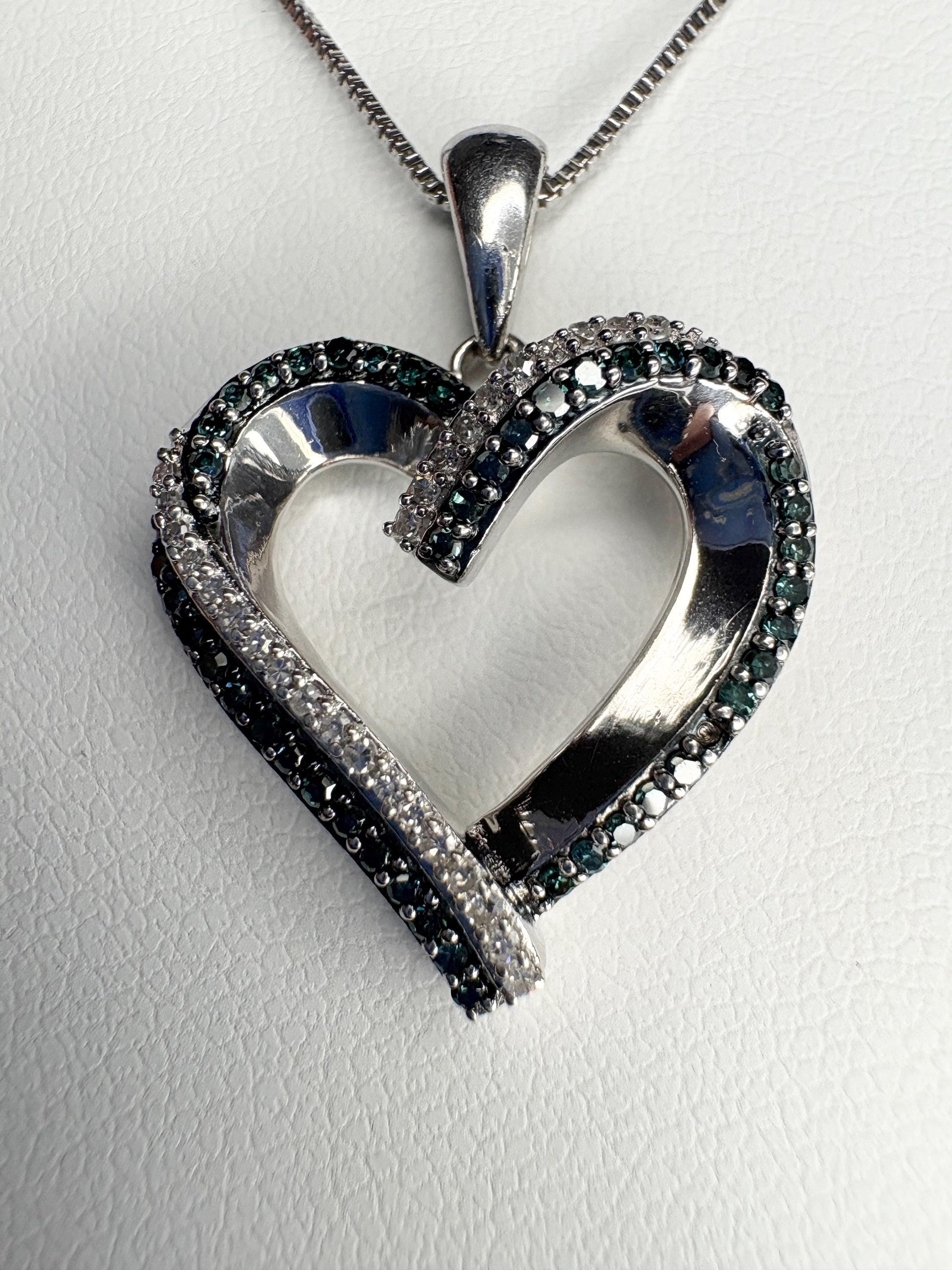 Sterling silver heart pendant necklace with blue and white diamonds.