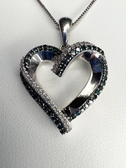 Sterling silver heart pendant necklace with blue and white diamonds.