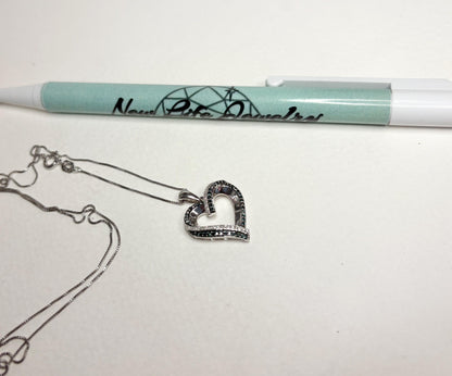 Sterling silver necklace with a heart pendant featuring blue and white diamonds.