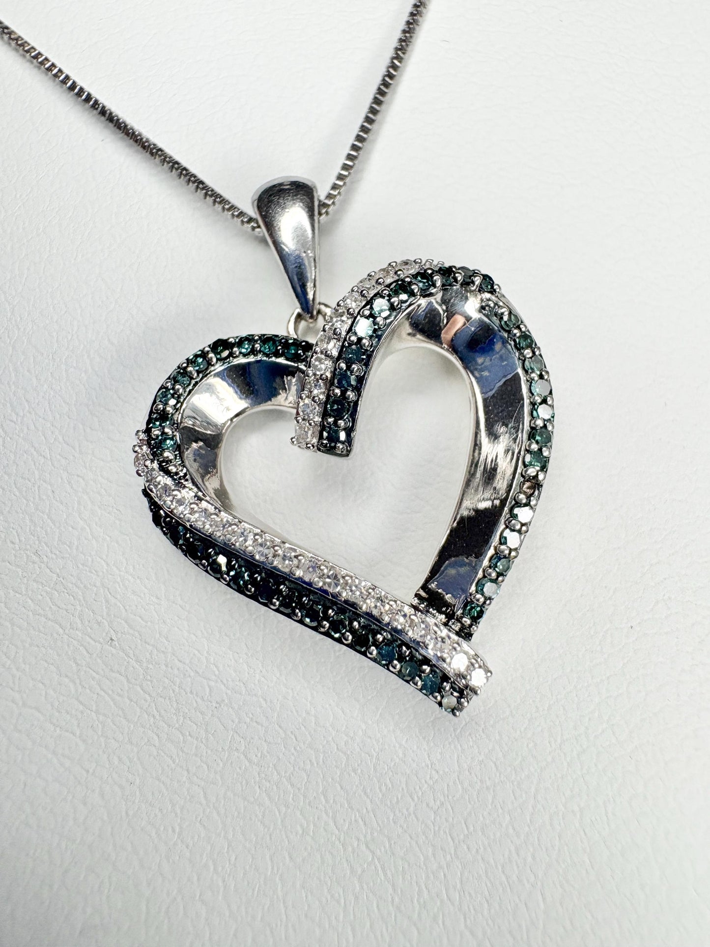 Sterling silver heart pendant necklace with blue and white diamonds.
