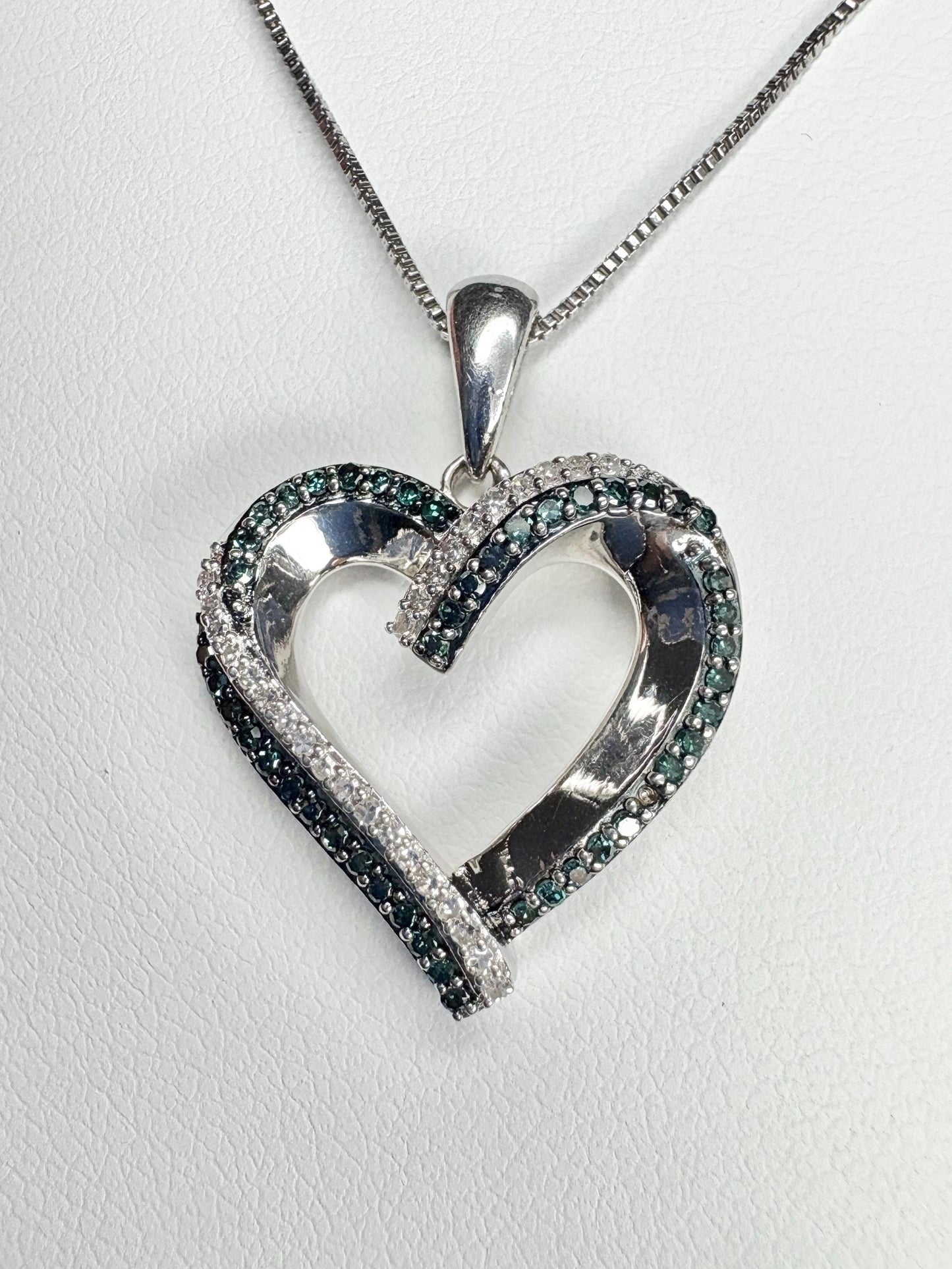 Sterling silver heart pendant necklace with blue and white diamonds.