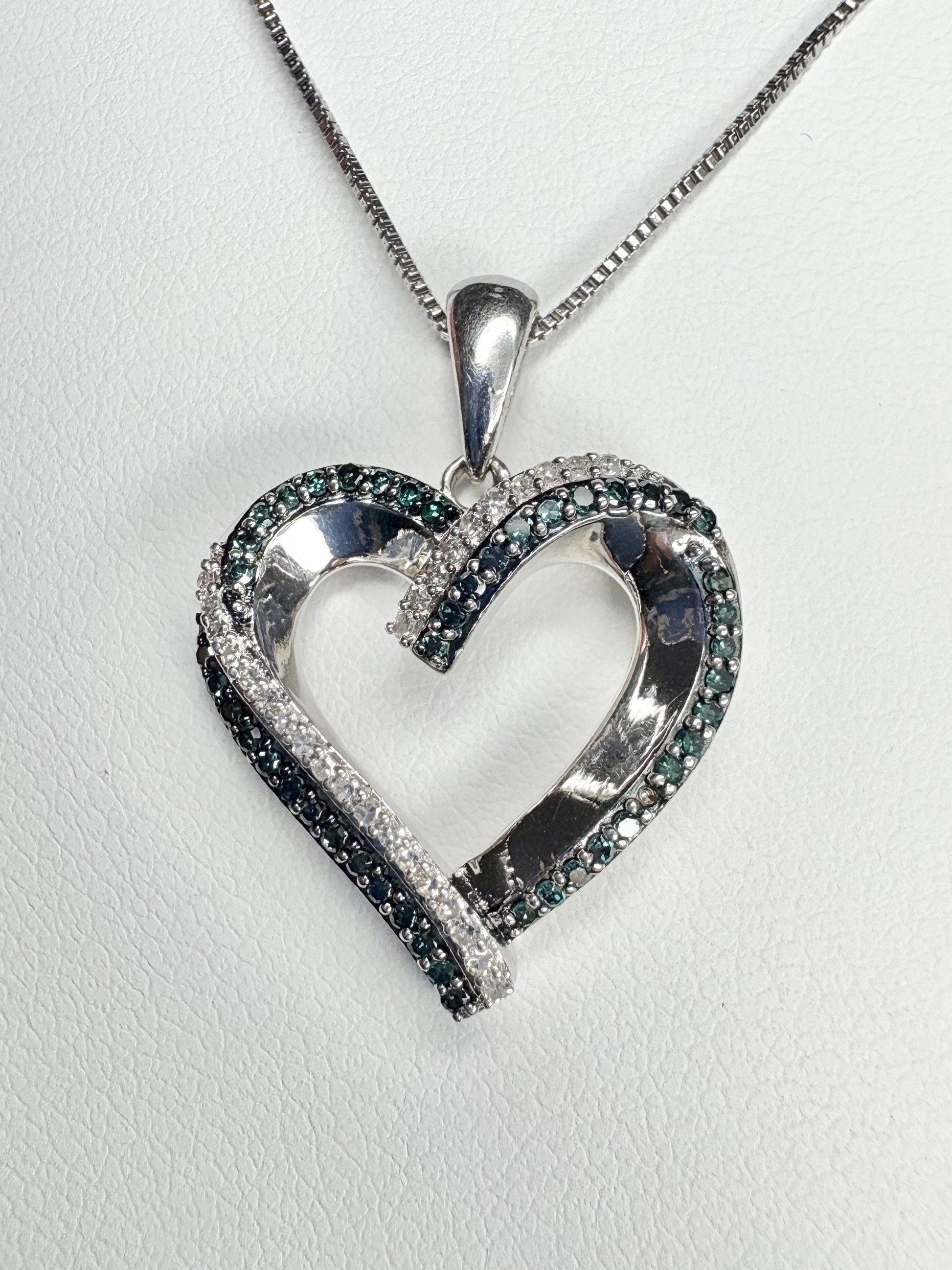 Sterling silver heart pendant necklace with blue and white diamonds.