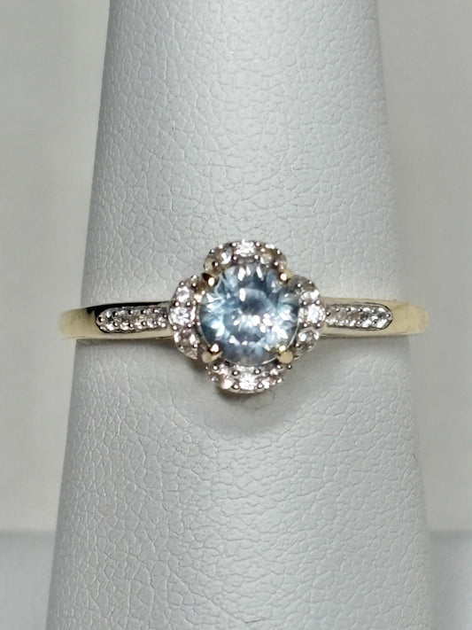9k gold ring with a Montana sapphire and white zircon in a floral halo design.