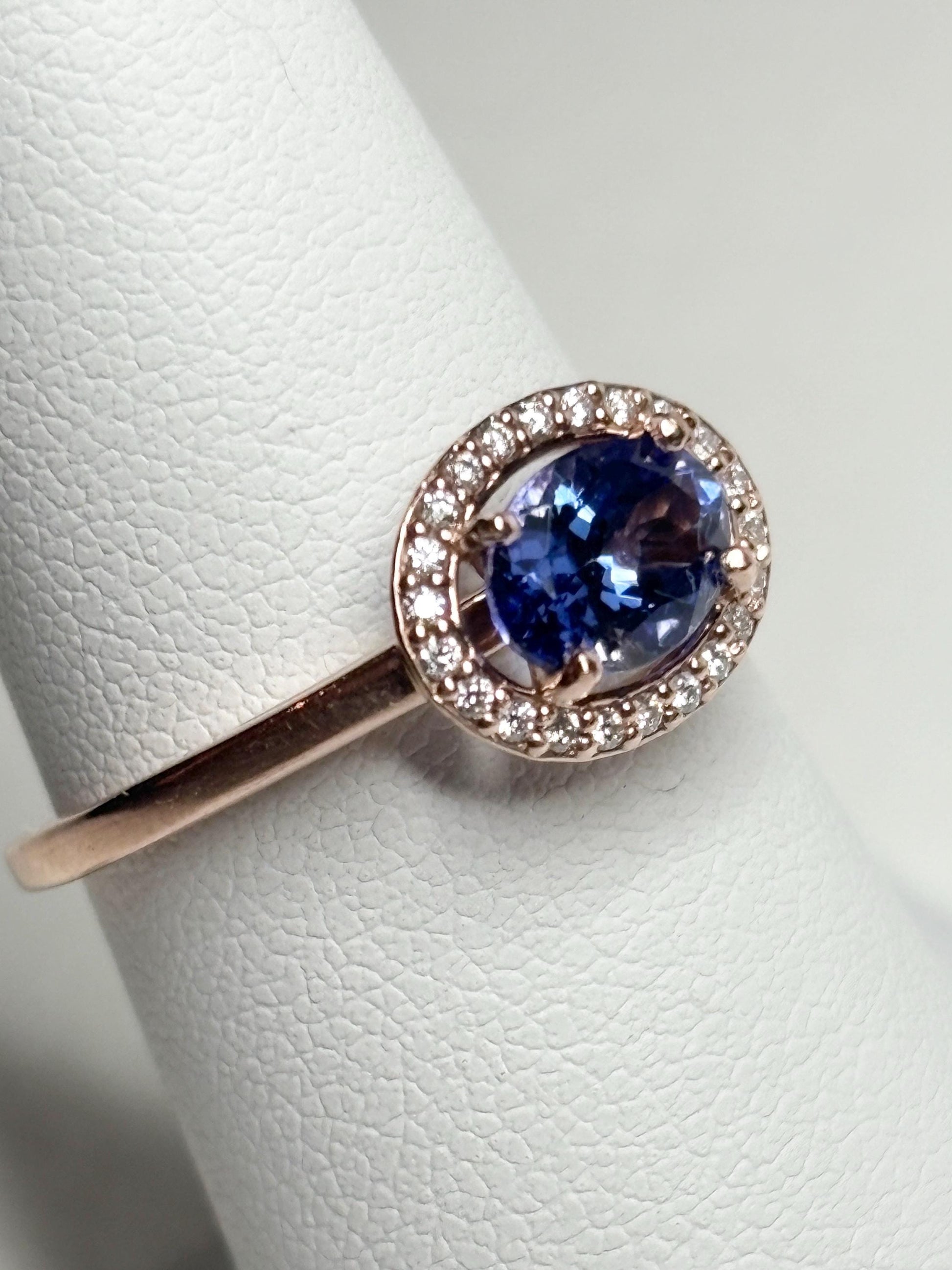14k rose gold ring with oval tanzanite and diamond halo.