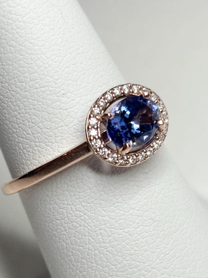 14k rose gold ring with oval tanzanite and diamond halo.