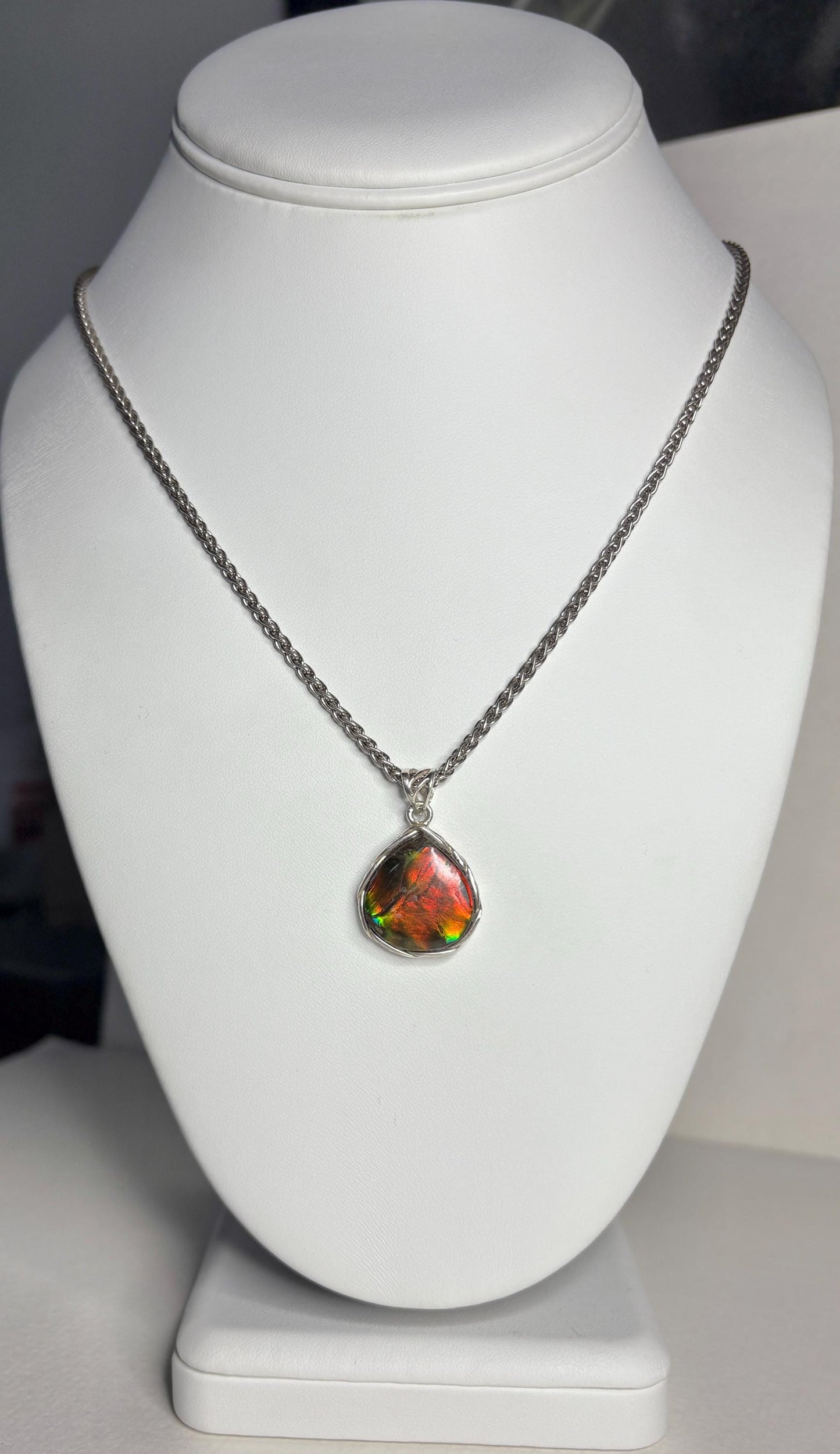 Sterling silver pendant necklace with a pear-shaped ammolite gemstone.
