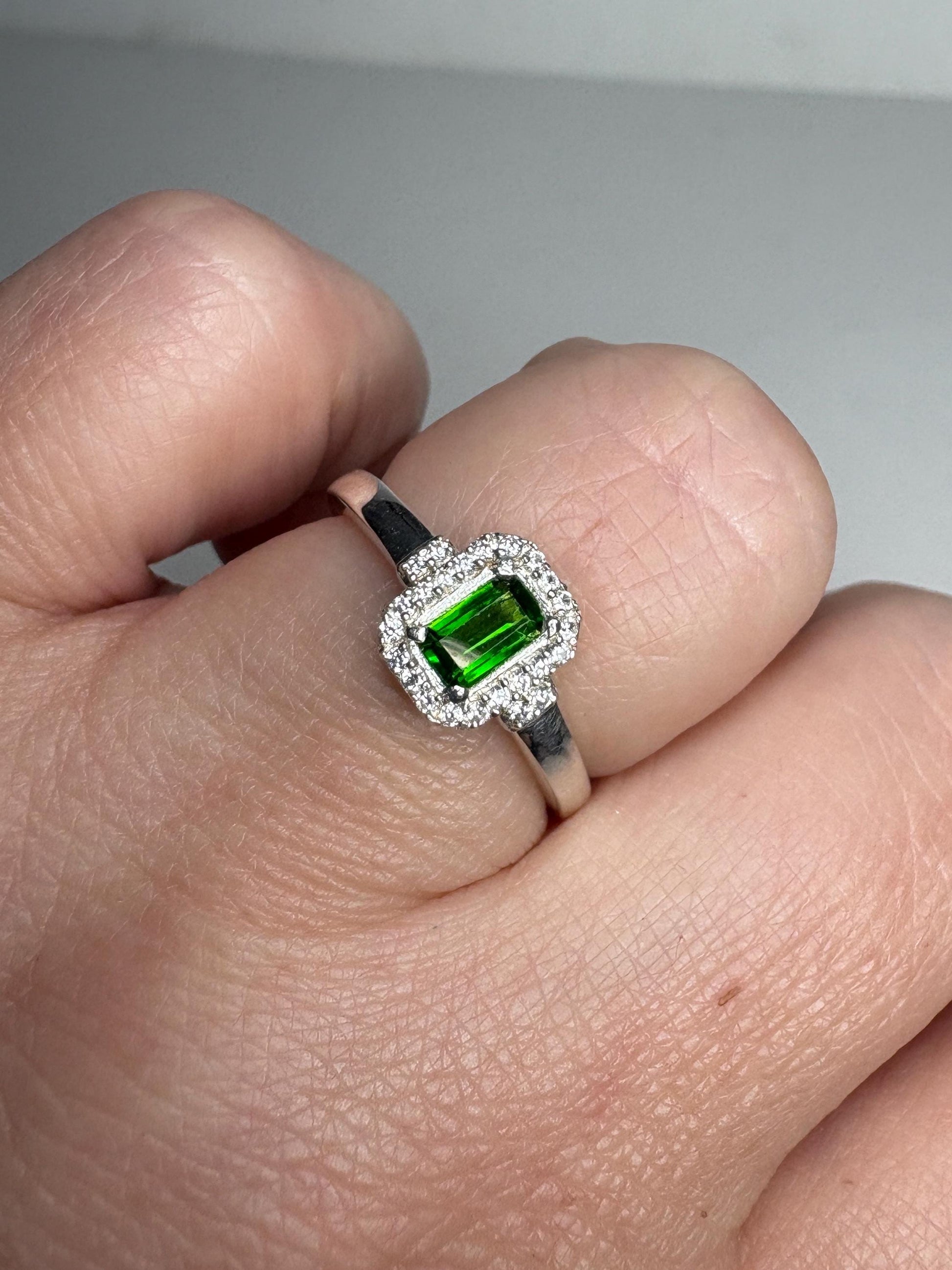 Sterling silver ring with emerald-cut chrome diopside and zircon halo.