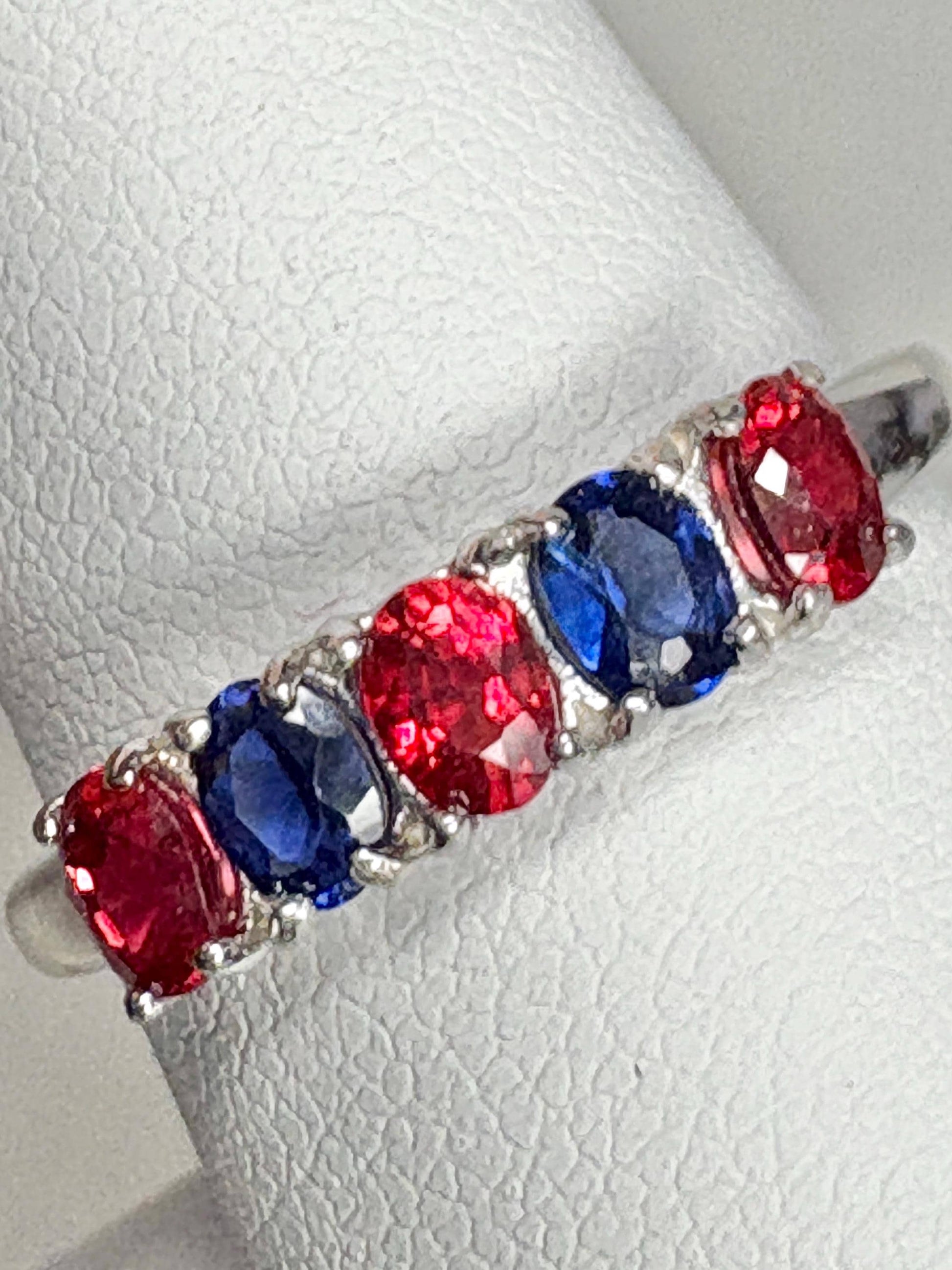 Sterling silver band ring with oval red and blue sapphires.