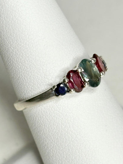 Sterling silver band ring with oval alexandrite, rhodolite garnets, and blue sapphires.