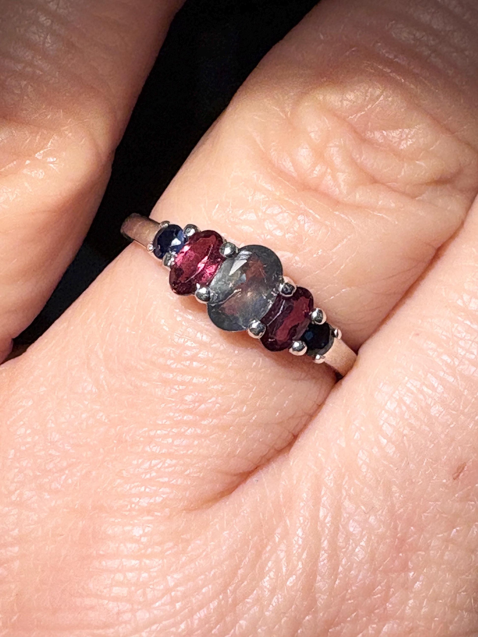 Sterling silver band ring with alexandrite, rhodolite garnets, and blue sapphires.
