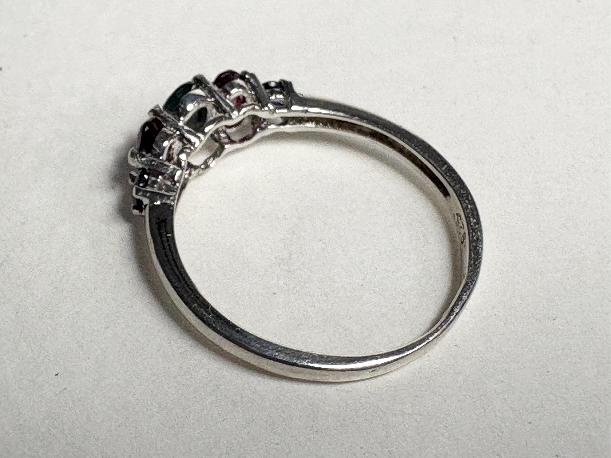 Sterling silver band ring with alexandrite, rhodolite garnets, and blue sapphires.