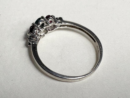 Sterling silver band ring with alexandrite, rhodolite garnets, and blue sapphires.