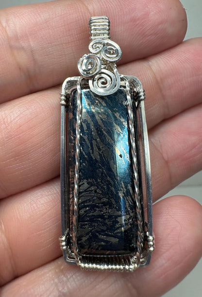 Sterling silver wire-wrapped pendant featuring a rectangular covellite stone with metallic gold and blue striations.