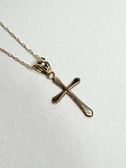Solid 10k gold cross pendant necklace with a fine rope chain.