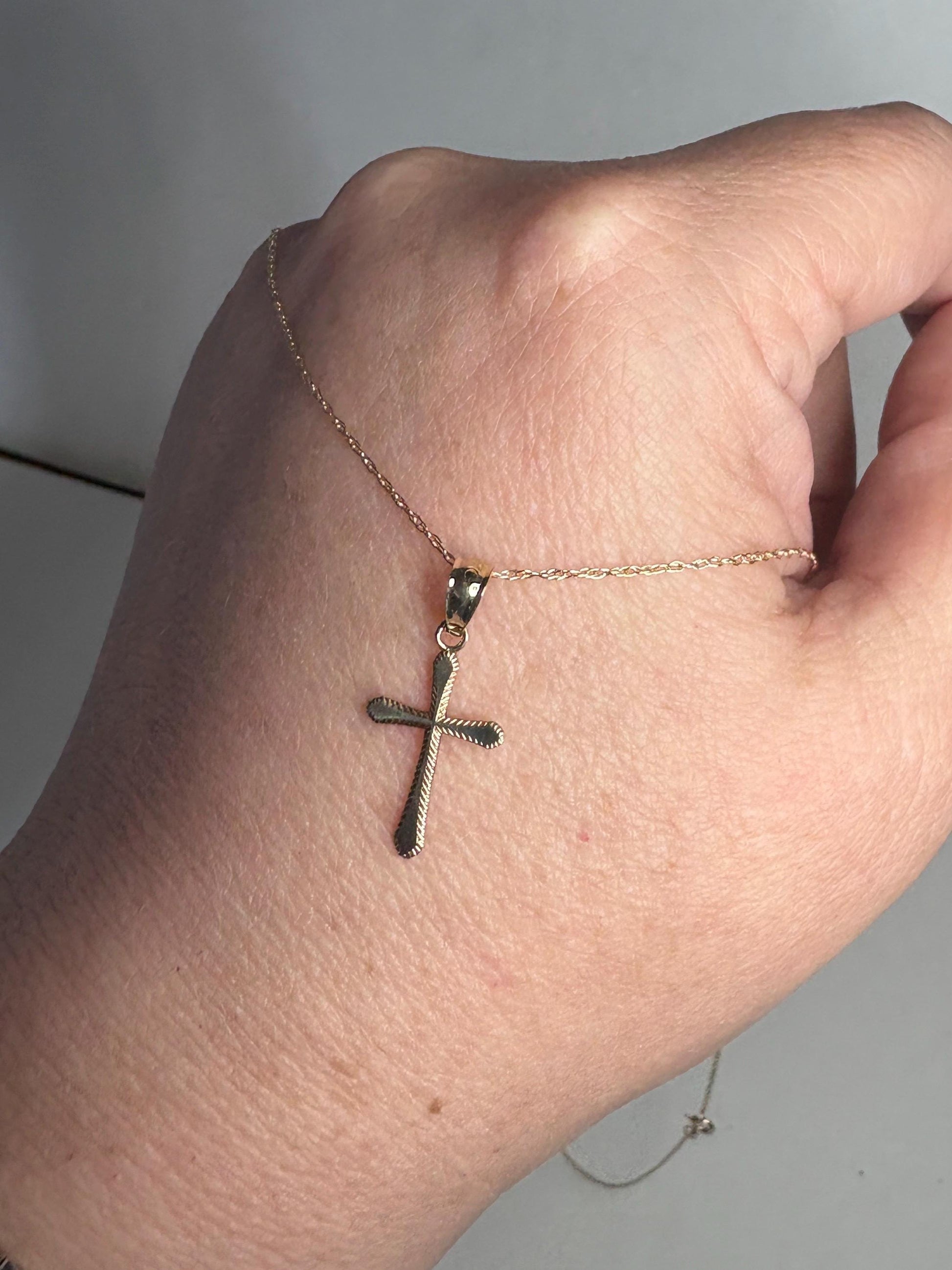 Solid 10k gold cross pendant necklace on a 19-inch rope chain.