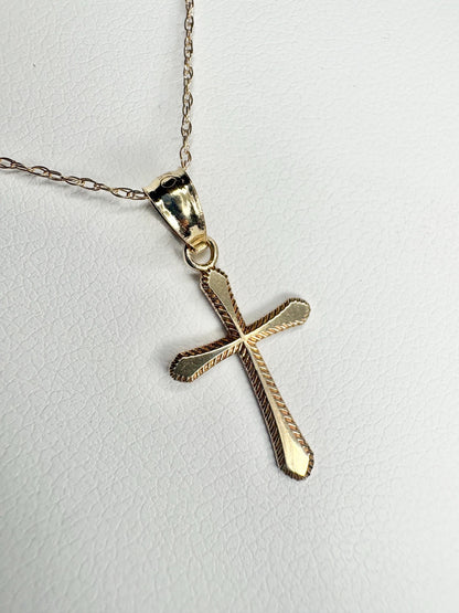 Solid 10k gold cross pendant necklace with a fine rope chain.